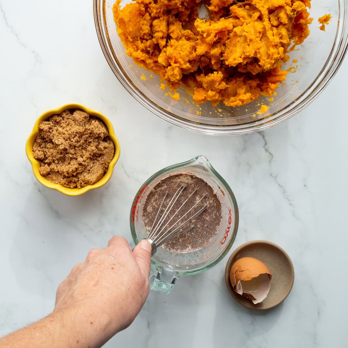 Combining the ingredients for sweet potato casserole.