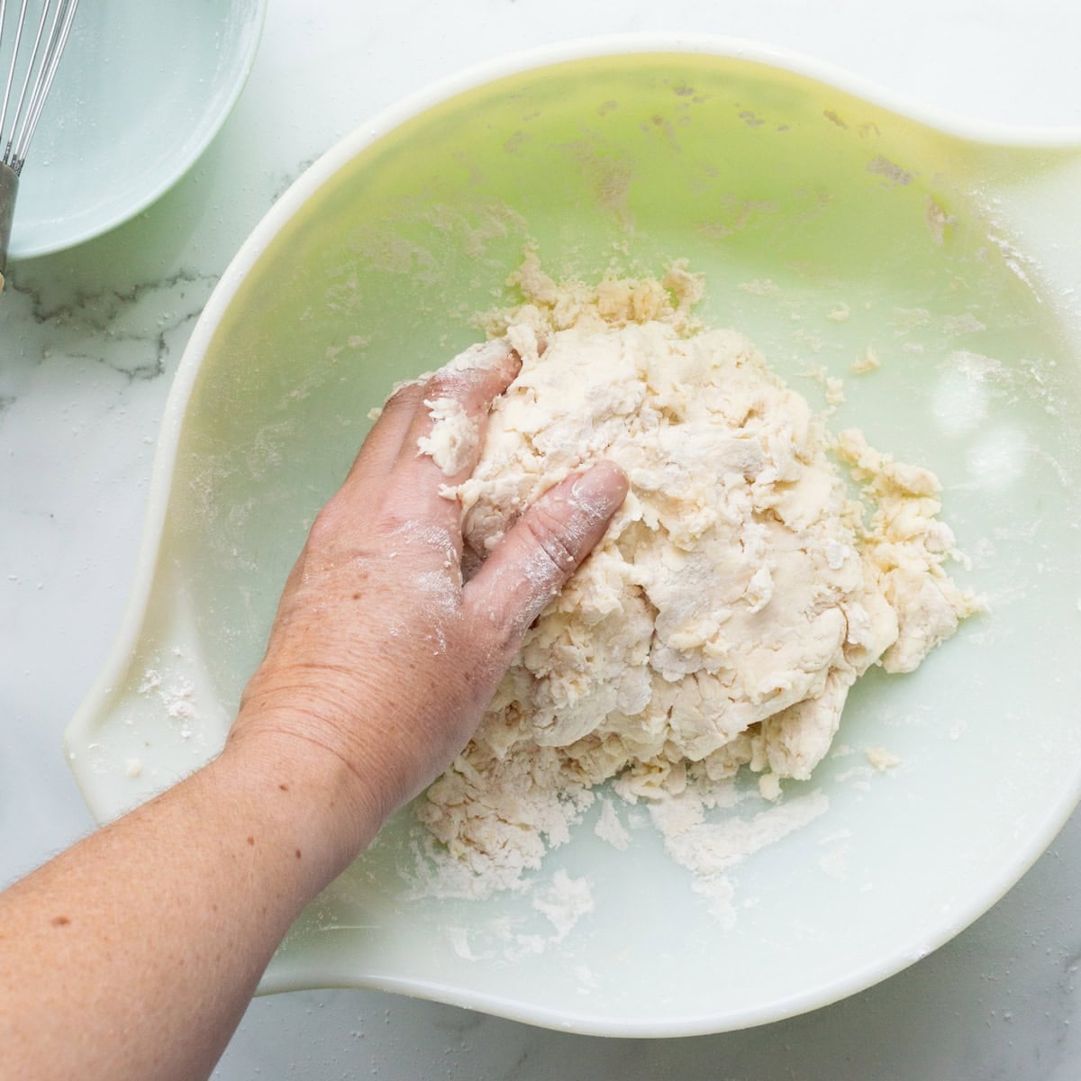 Making butter pie crust in a large bowl.