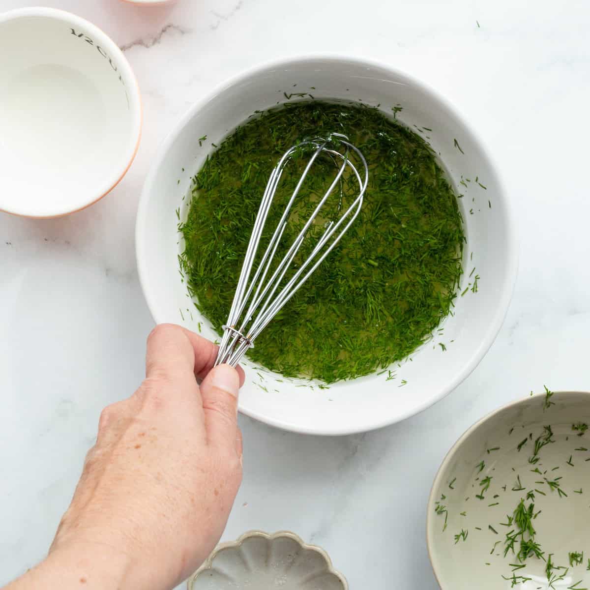 Whisking together the marinade for pickled shrimp.