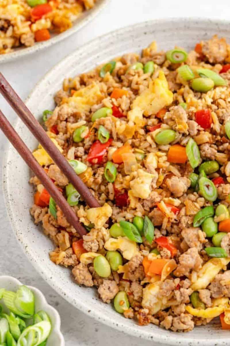 Ground turkey fried rice with scrambled eggs, vegetables, edamame, and sliced green onions.