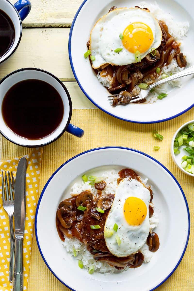 Hawaiian loco moco served over white rice with brown gravy, mushrooms, green onions, and a fried egg.