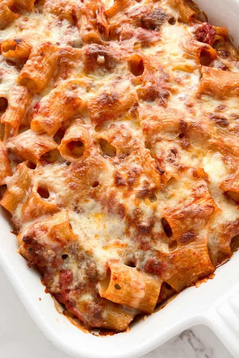 Rigatoni al forno baked with tomato sauce and a golden layer of melted cheese.
