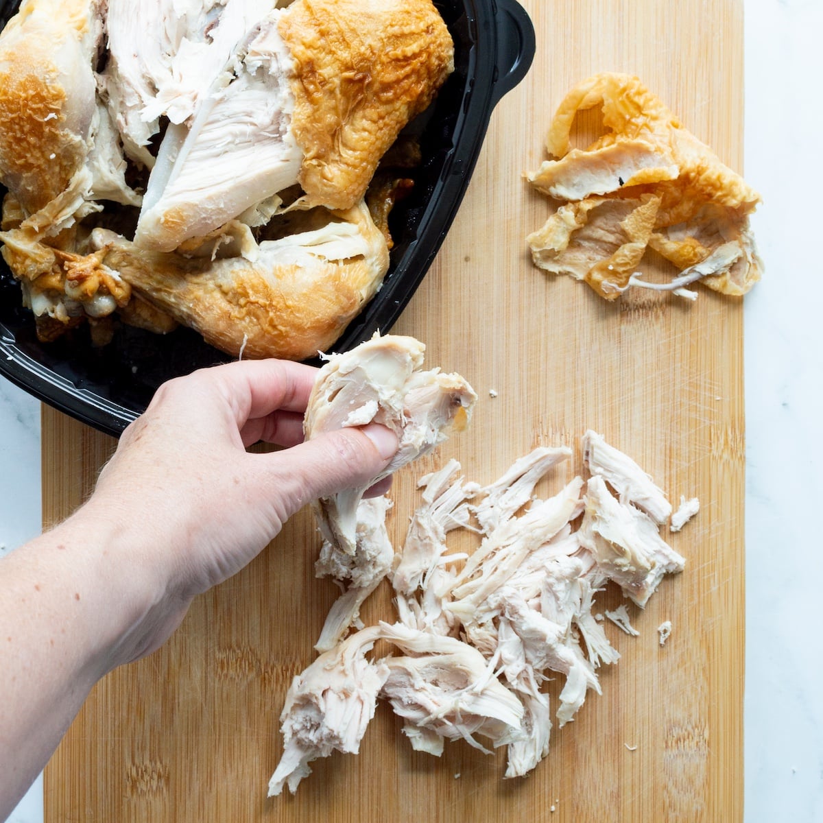 Shredding rotisserie chicken.