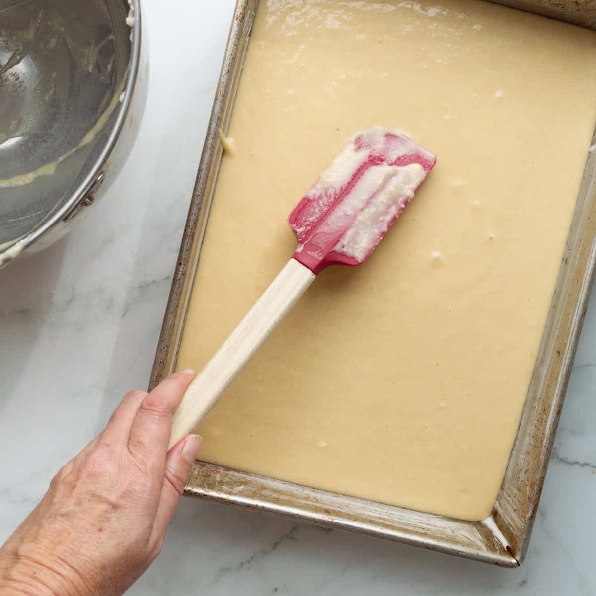 Spread cake batter into a 13 - x 9-inch baking pan.