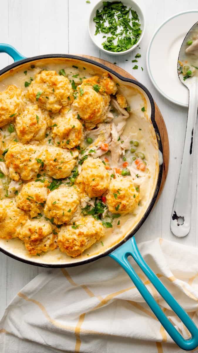 Red Lobster biscuit chicken pot pie with golden cheddar biscuits over creamy shredded chicken, peas, and carrots, topped with fresh parsley.